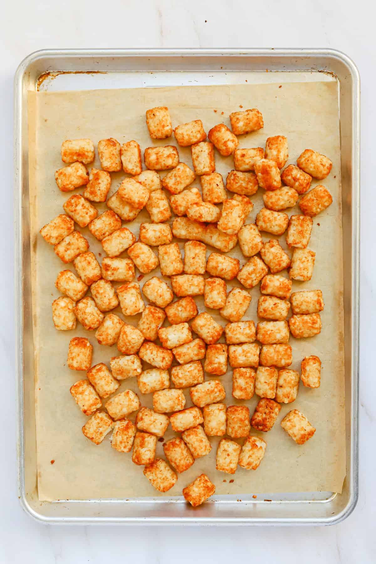 Crispy baked tater tots on a sheet pan.