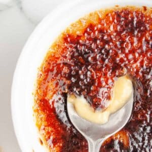 Close up of a spoon breaking into Butterscotch Creme Brulee