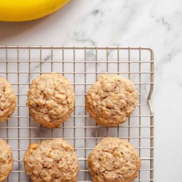 Banana Oatmeal Cookies on wire rack next to whole bananas