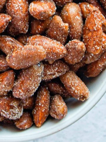 White bowl of Honey Cinnamon Candied Almonds