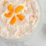 Cottage Cheese Jello salad in a glass bowl topped with mandarin oranges