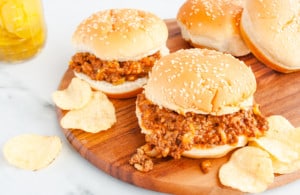 Assembled Sloppy Joes with Chicken Gumbo Soup on a wooden tray with potato chips