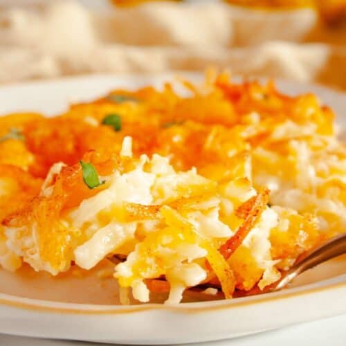 Cheesy hashbrowns on a white plate