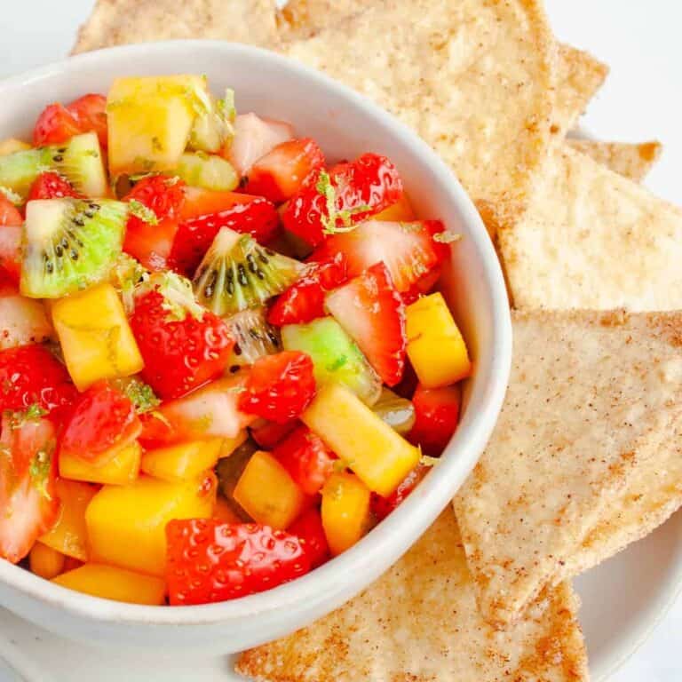 Fruit Salsa in a white bowl alongside homemade cinnamon tortilla chips