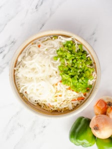 Bowl of cabbage, carrots, white onion and green pepper