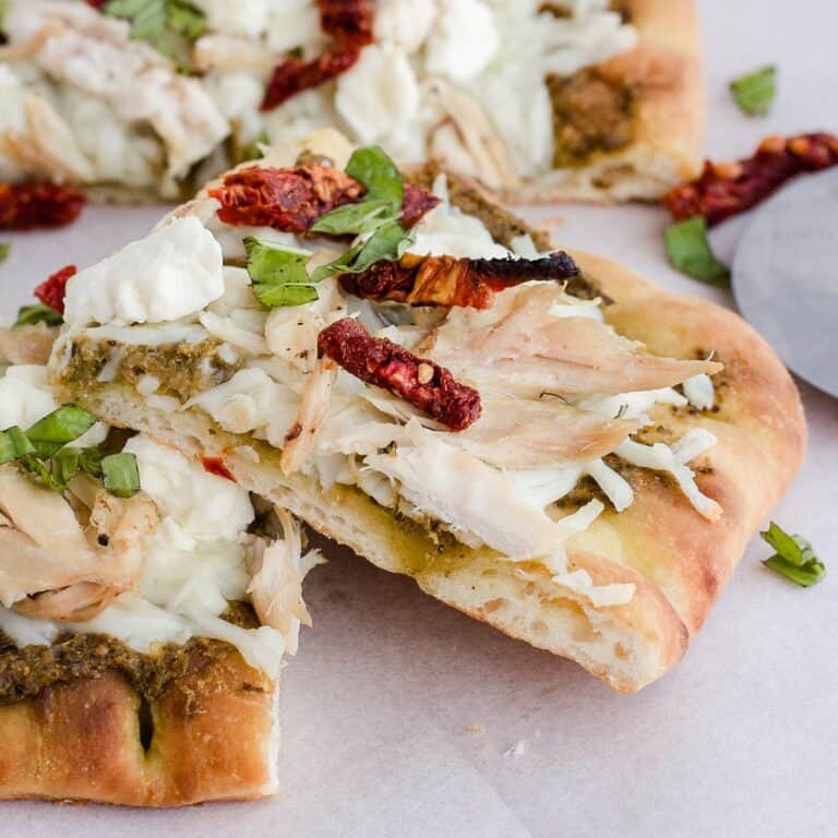 Pesto chicken flatbread pizza cut into squares
