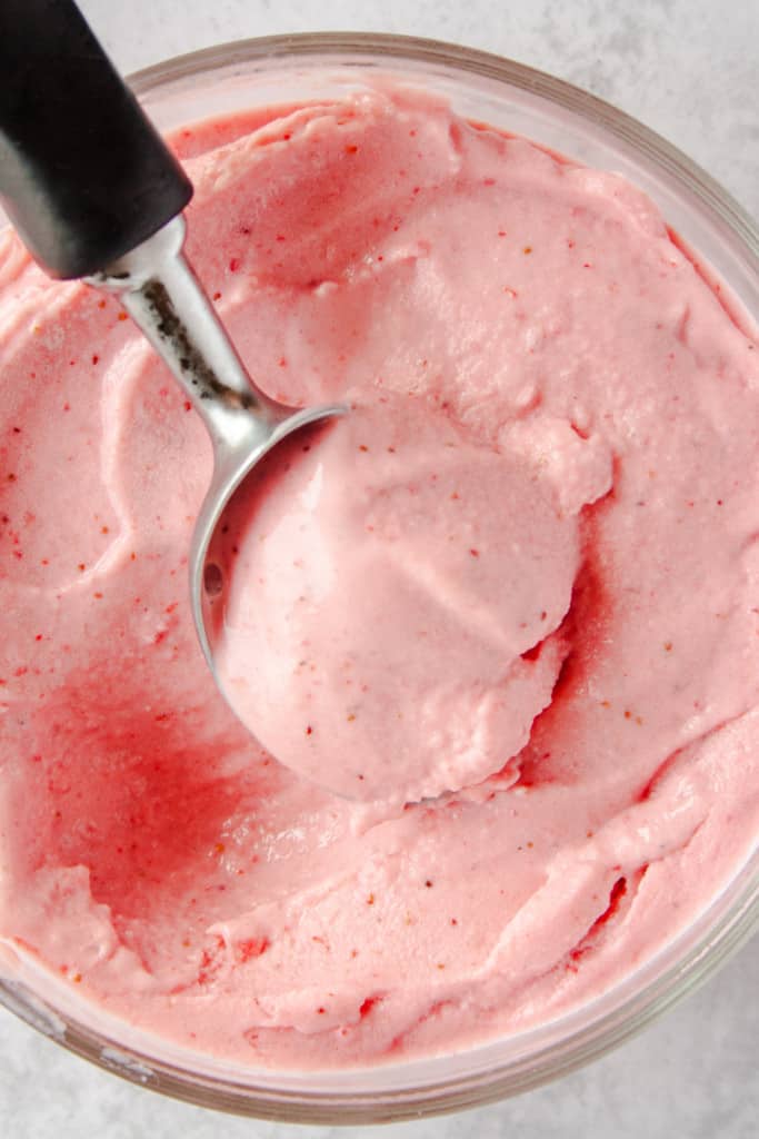Ice cream scoop scooping out strawberry frozen yogurt