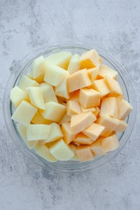 Diced potato and rutabaga divided in glass bowl