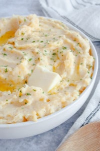 Mashed rutabaga and potato in a white serving dish