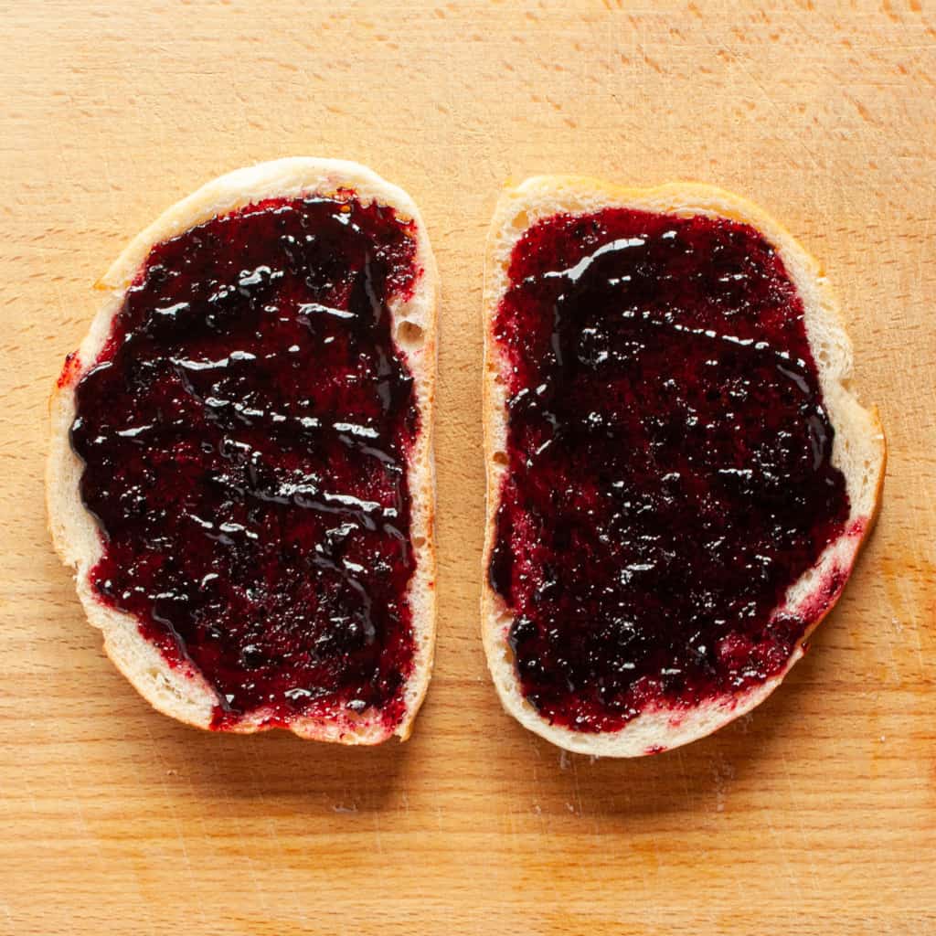 Blueberry jam spread on 2 slices of sourdough bread