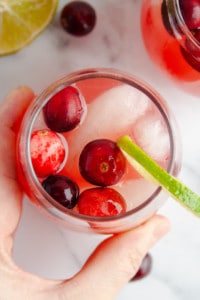 Overhead shot of hand grabbing glass of Holiday Punch