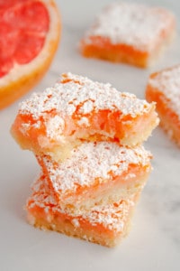 Grapefruit Bars stacked on top of each other with the top of bitten out of