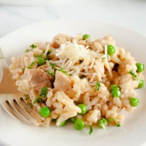 chicken risotto served on a white plate