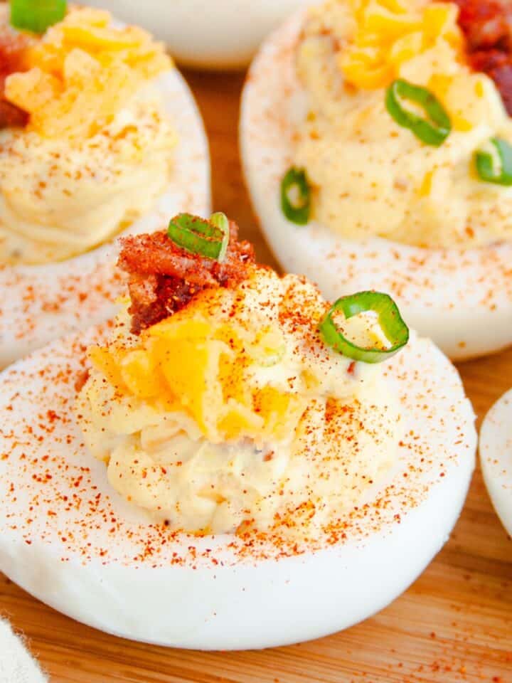 Loaded Deviled Eggs on wooden tray