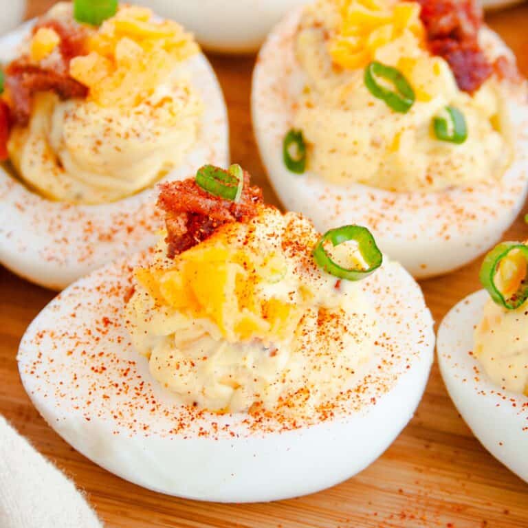 Loaded Deviled Eggs on wooden tray