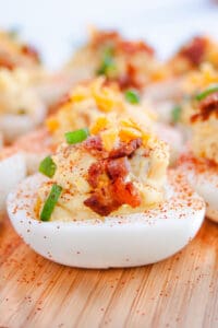 Side shot of Loaded Deviled Eggs on wooden tray