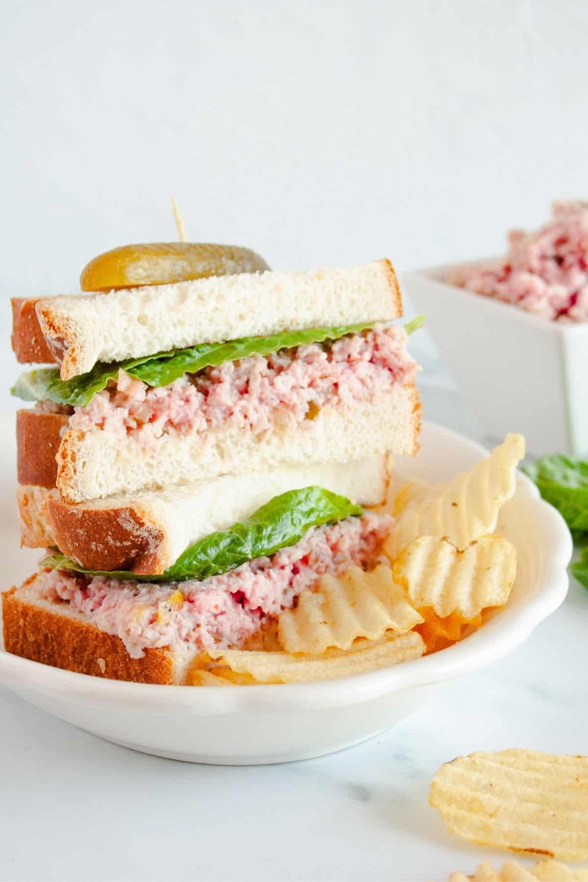 Ham salad on white bread served with chips