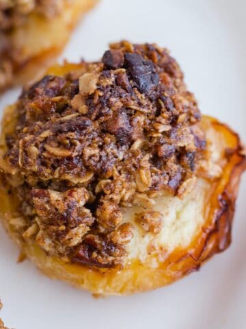 Close up of baked apple with oat crumble topping