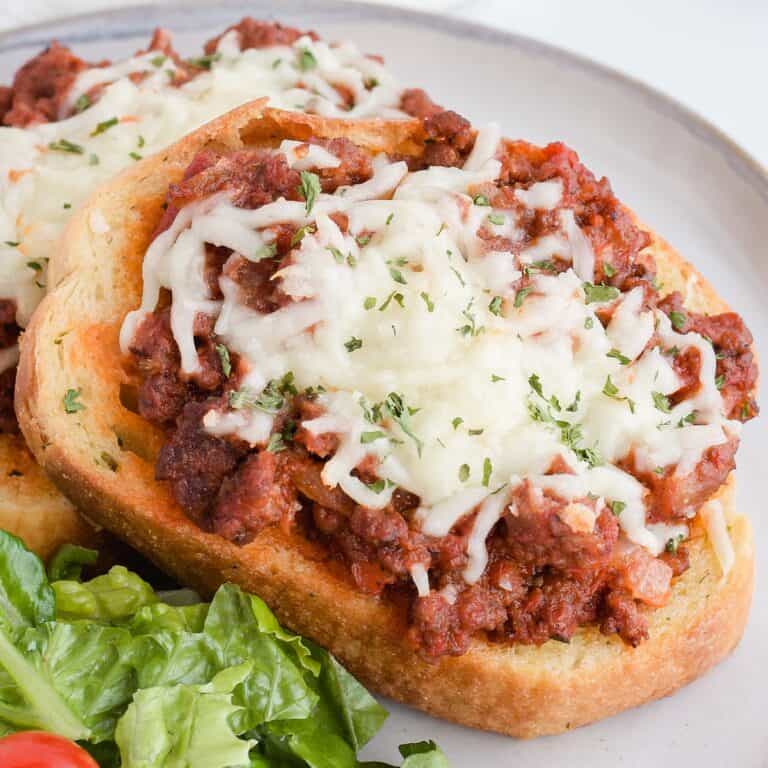 Italian sloppy Joe on a plate with a green salad