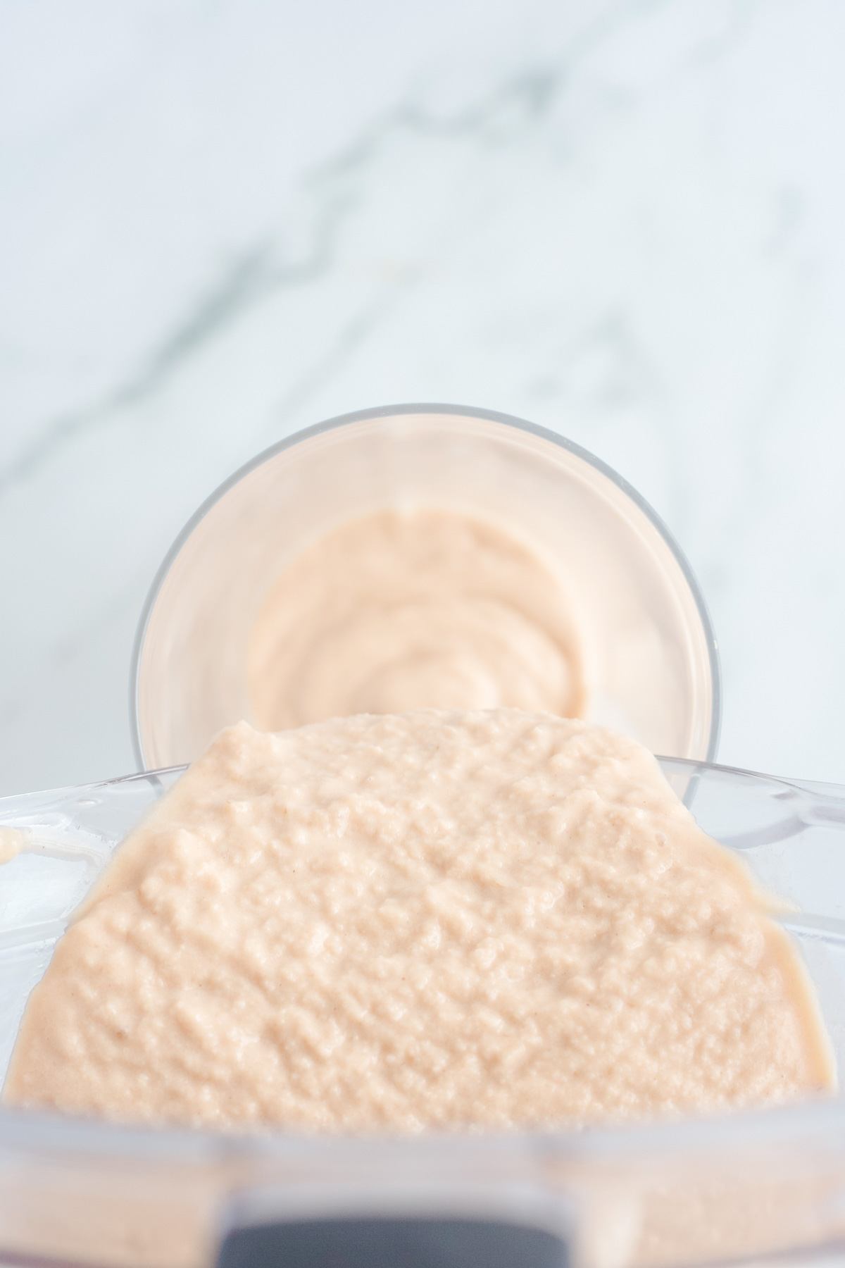 Overhead shot of milkshake being poured into glass