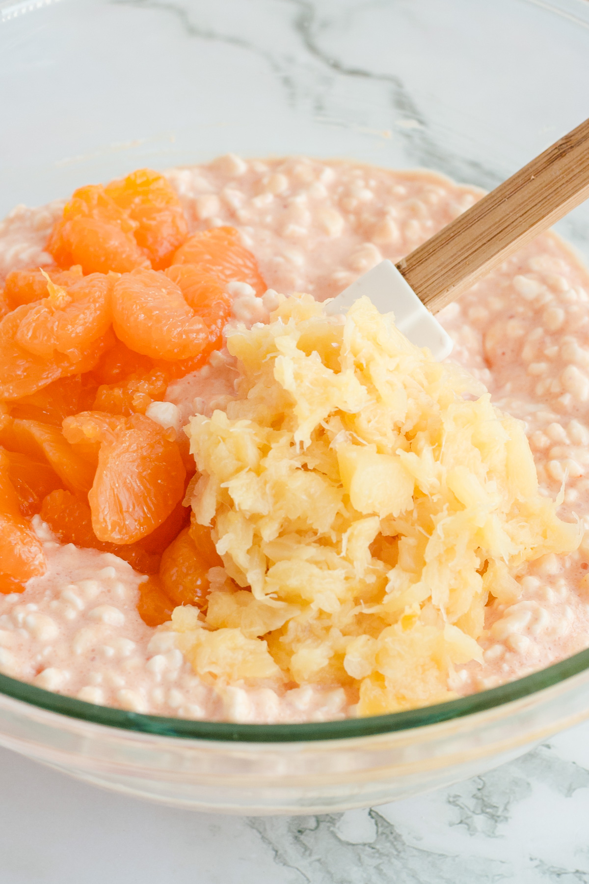 Crushed pineapple and mandarin oranges on top of orange cottage cheese