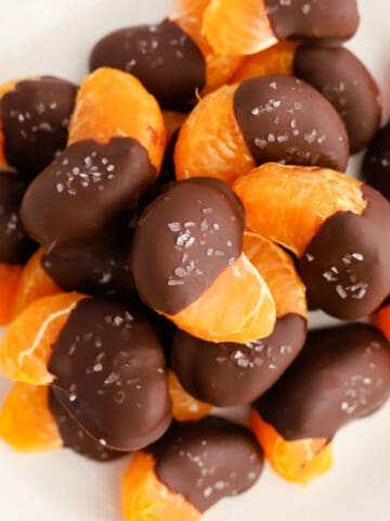 Dipped oranges on white plate