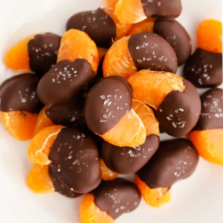 Dipped oranges on white plate