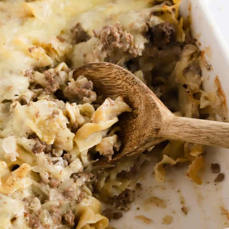 Square image of wooden spoon scooping out hot dish.
