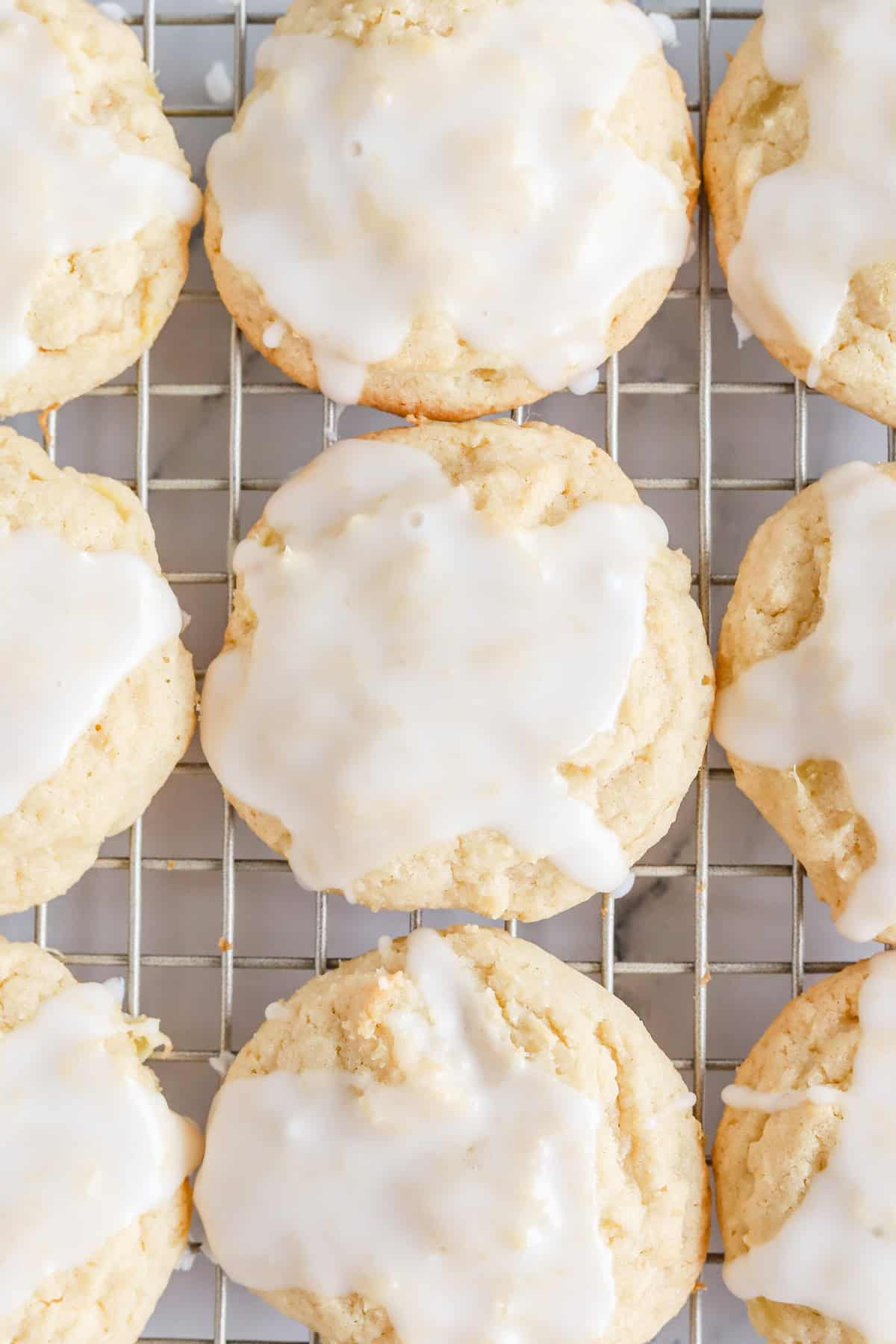 Pineapple cookies with glaze on a gold wire rack