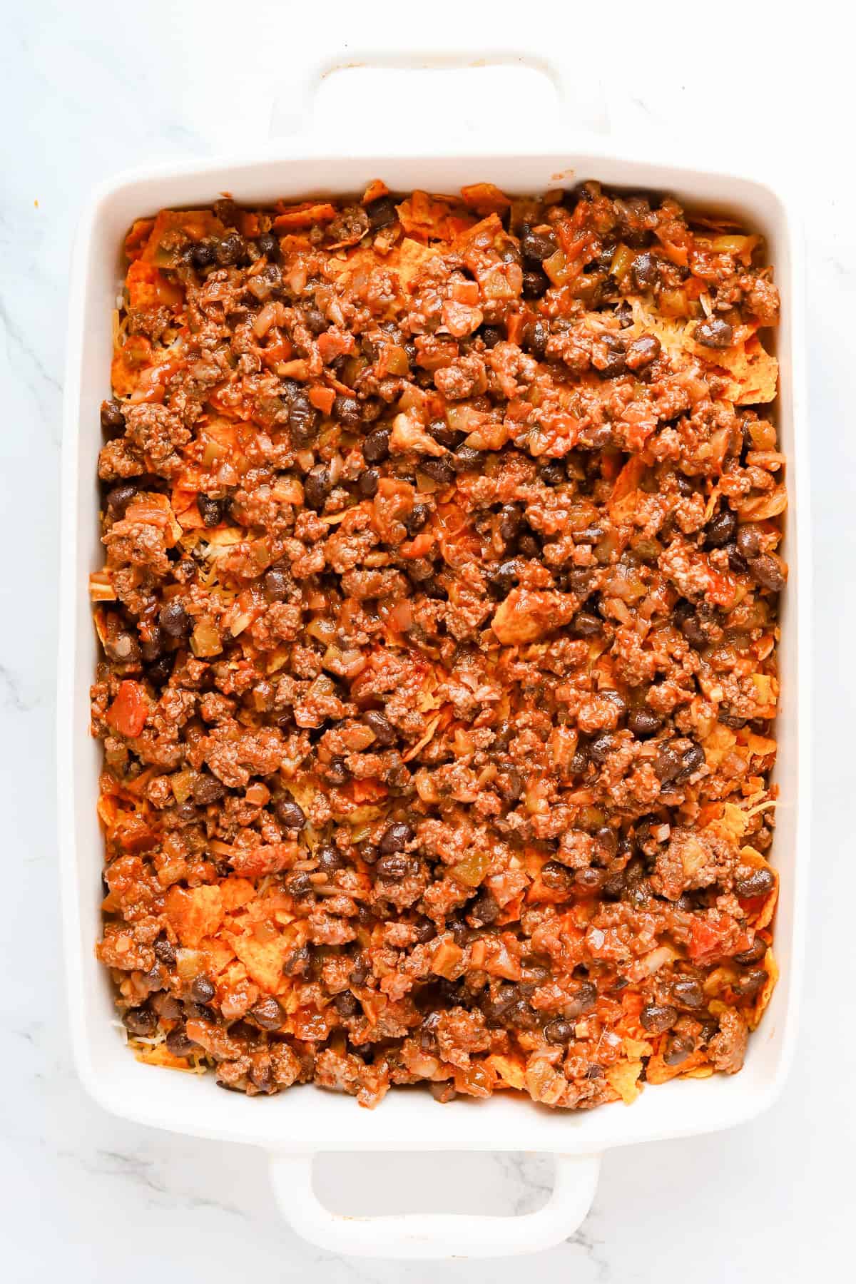 Second layer of beef and black bean mixture on top of casserole.