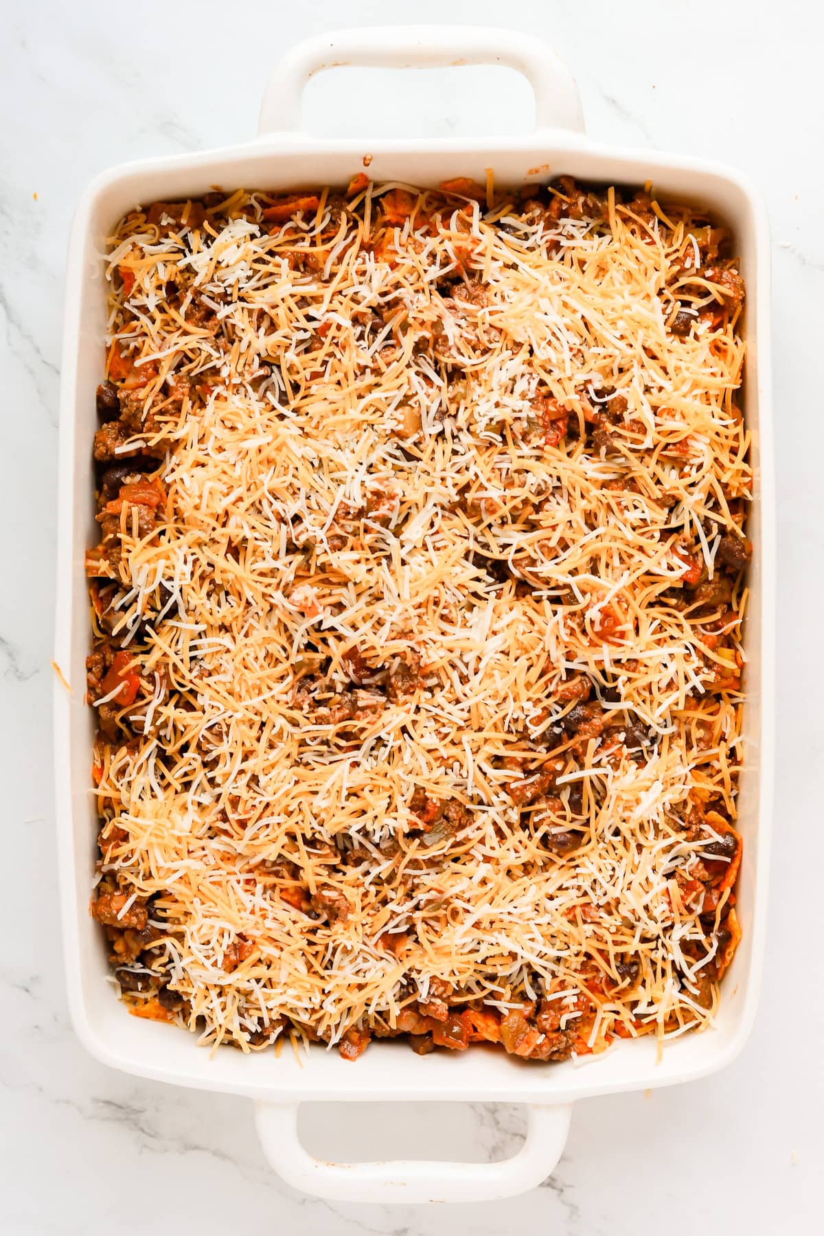 Second layer of shredded cheese on top of casserole.