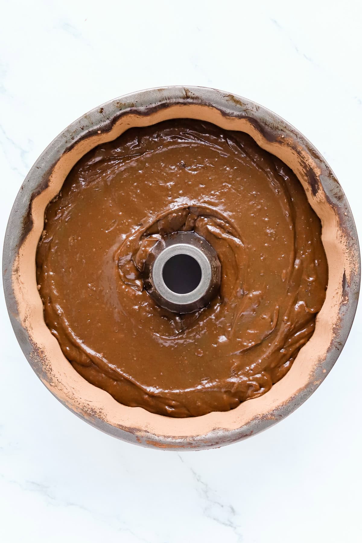 Chocolate mayo cake batter in a greased bundt pan.
