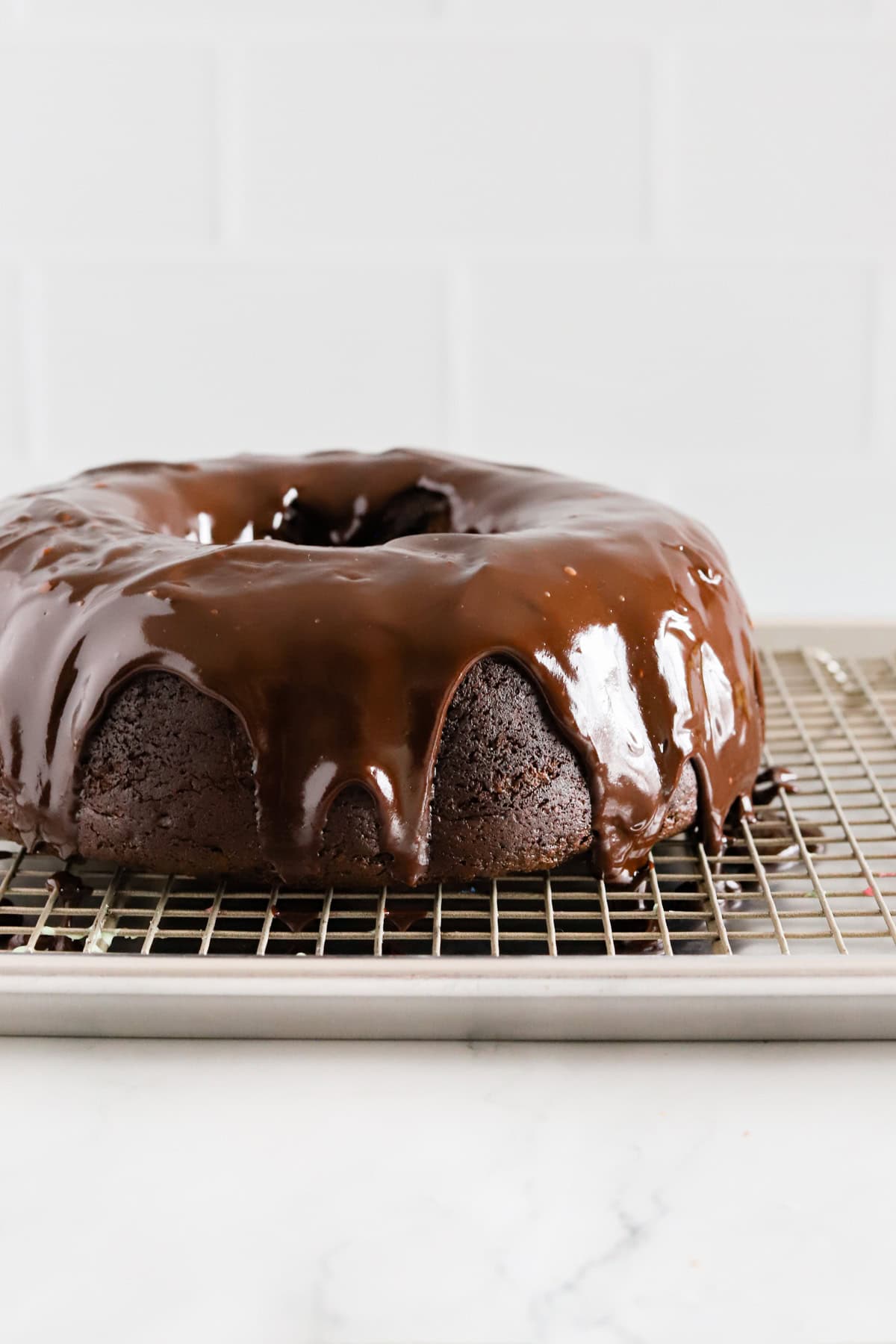 Chocolate mayonnaise cake with chocolate ganache dripping down the sides.