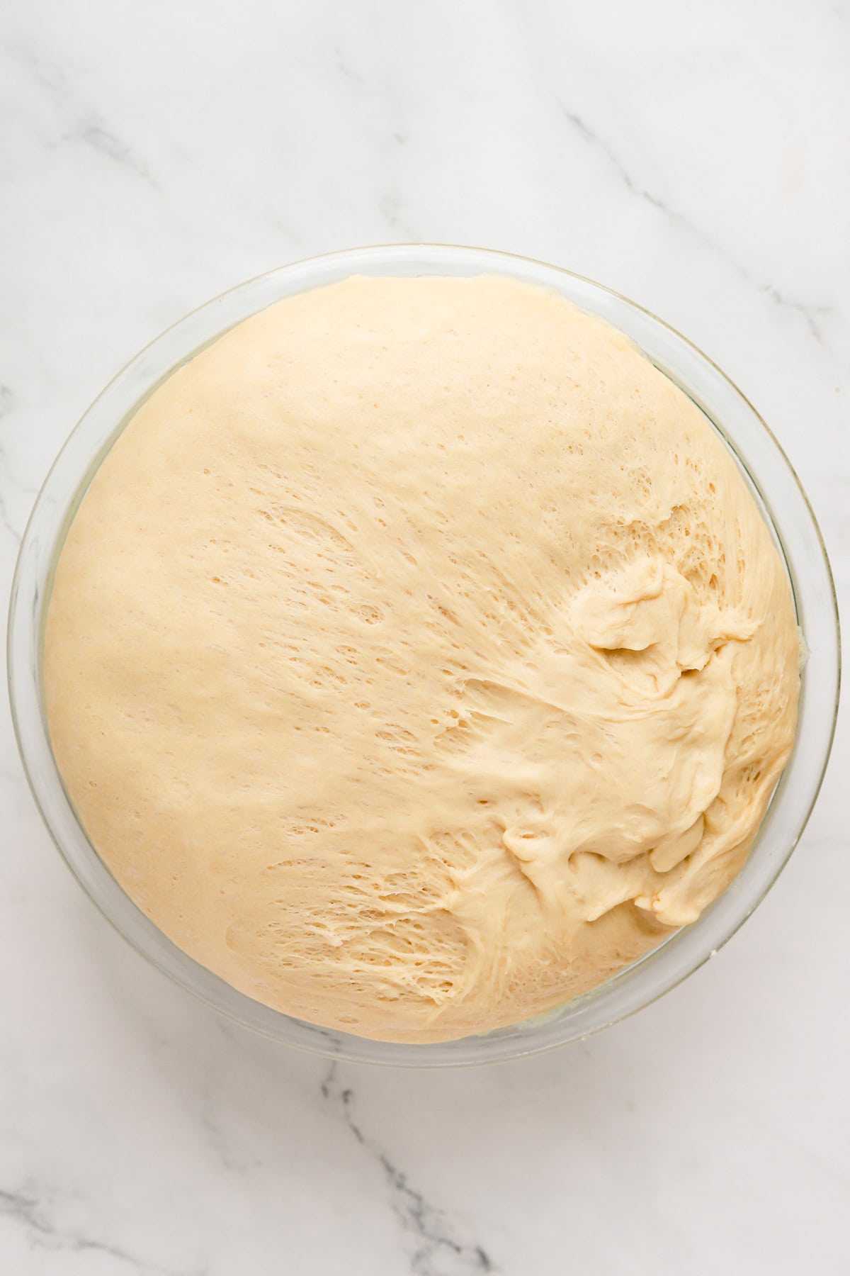 Proofed potica dough in glass bowl.