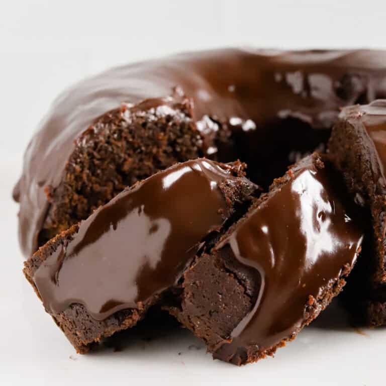Two slices of chocolate mayo cake shingled alongside the rest of the bundt cake.