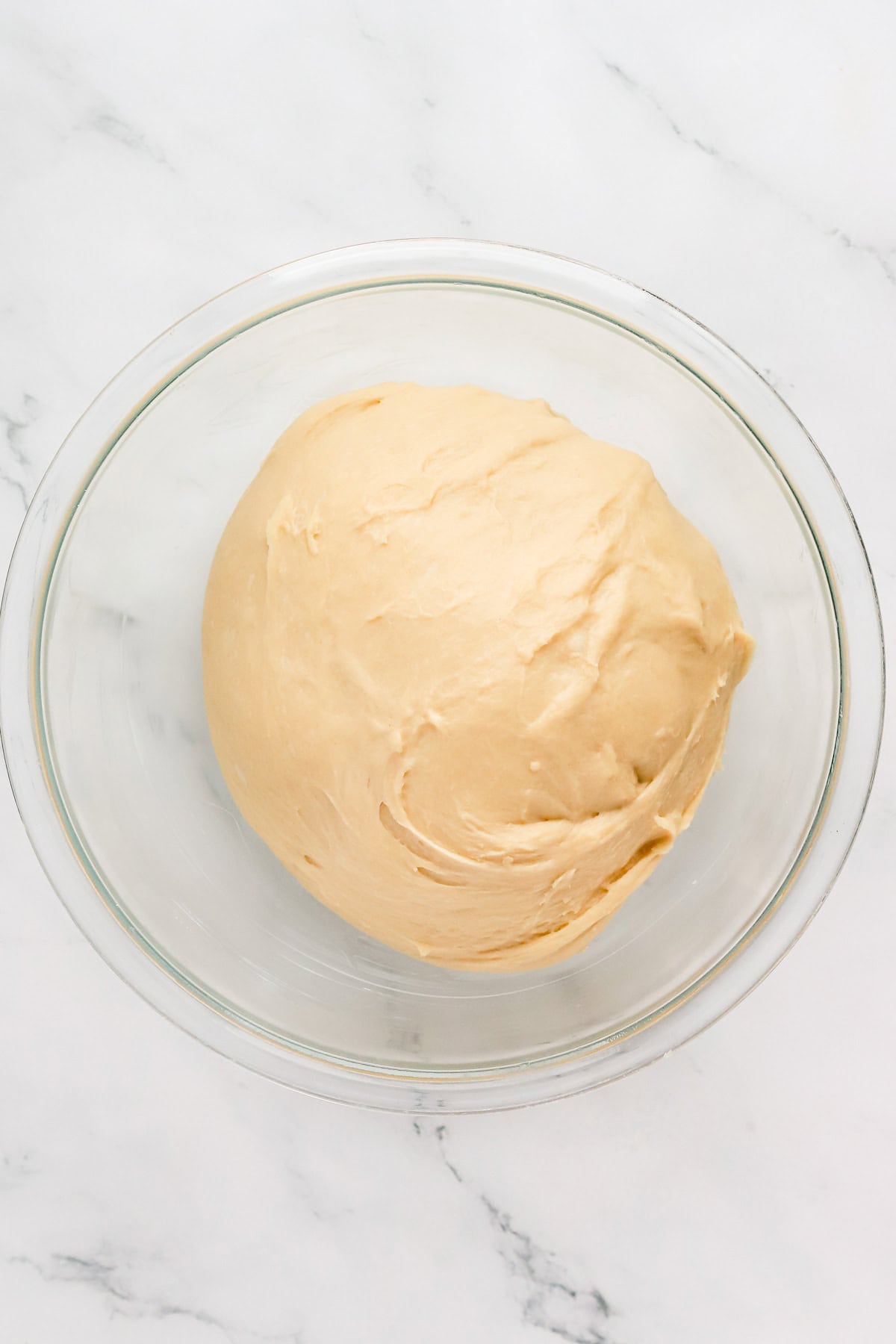 Yeast potica dough in glass bowl before proofing.