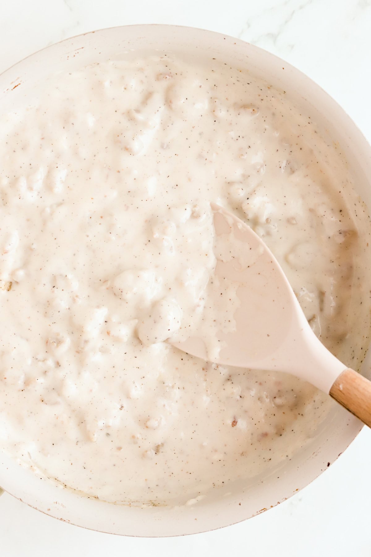 Homemade sausage gravy in a skillet.