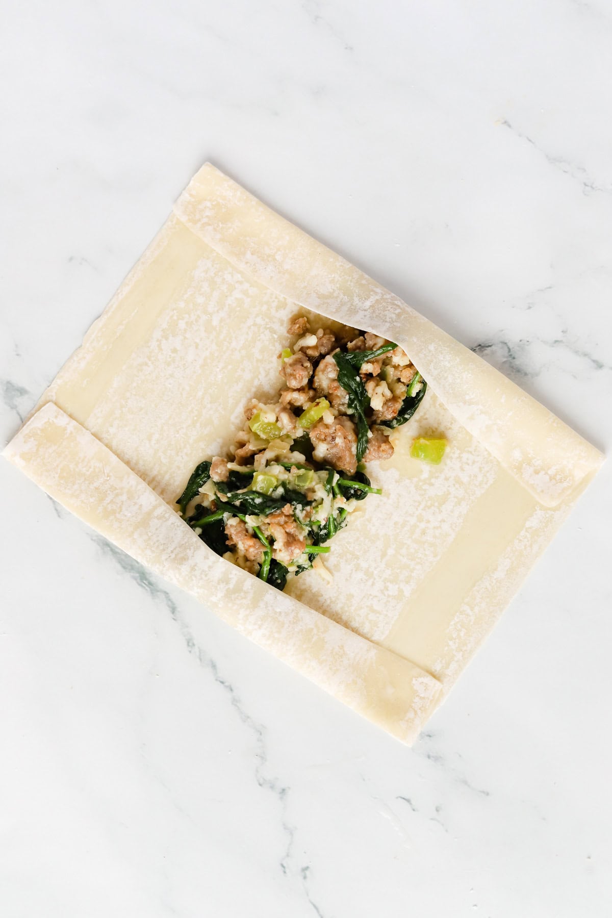 Sides of egg roll wrapper folded in.