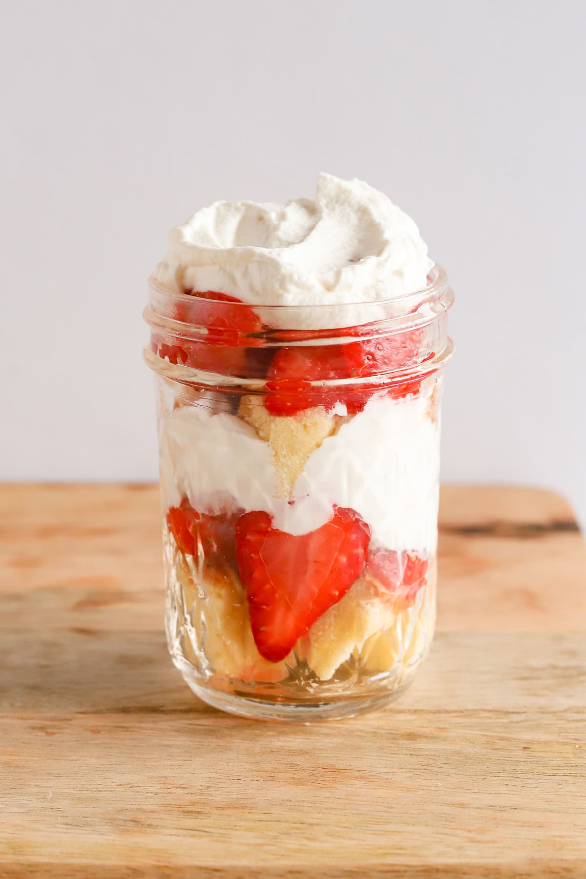 Finished strawberry shortcake parfait in mason jar