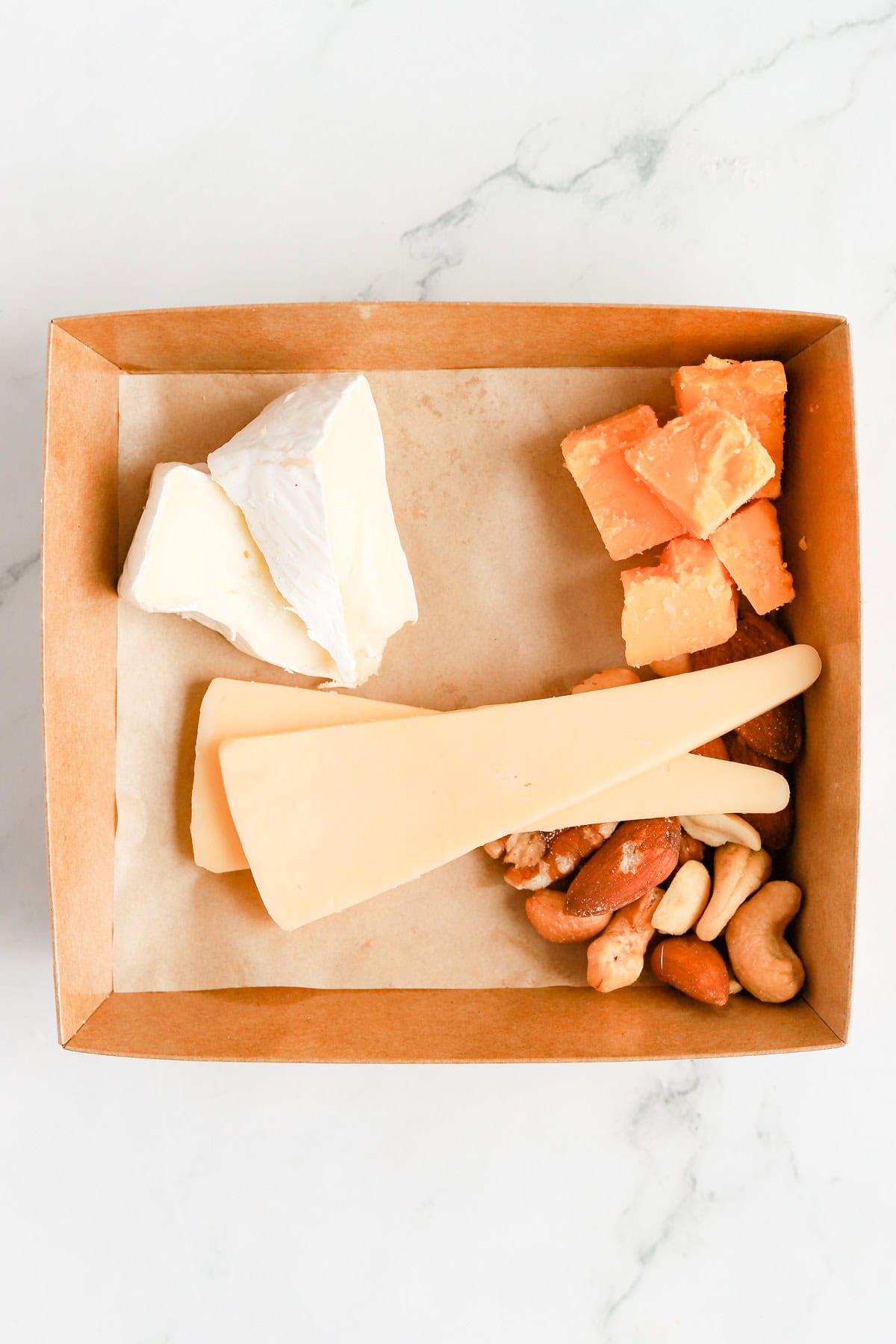 Three cheeses added to the box with mixed nuts