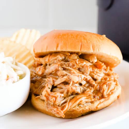 Featured image of bbq pulled chicken sandwich on a white plate