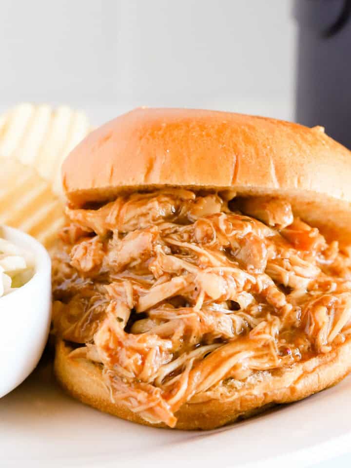 Featured image of bbq pulled chicken sandwich on a white plate