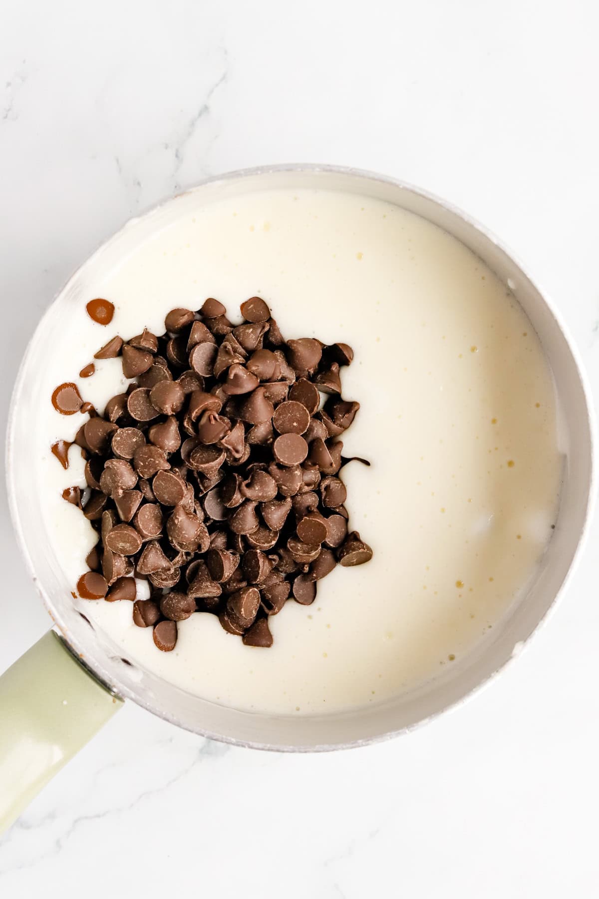 Chocolate chips in a saucepan of melted marshmallows, milk and butter