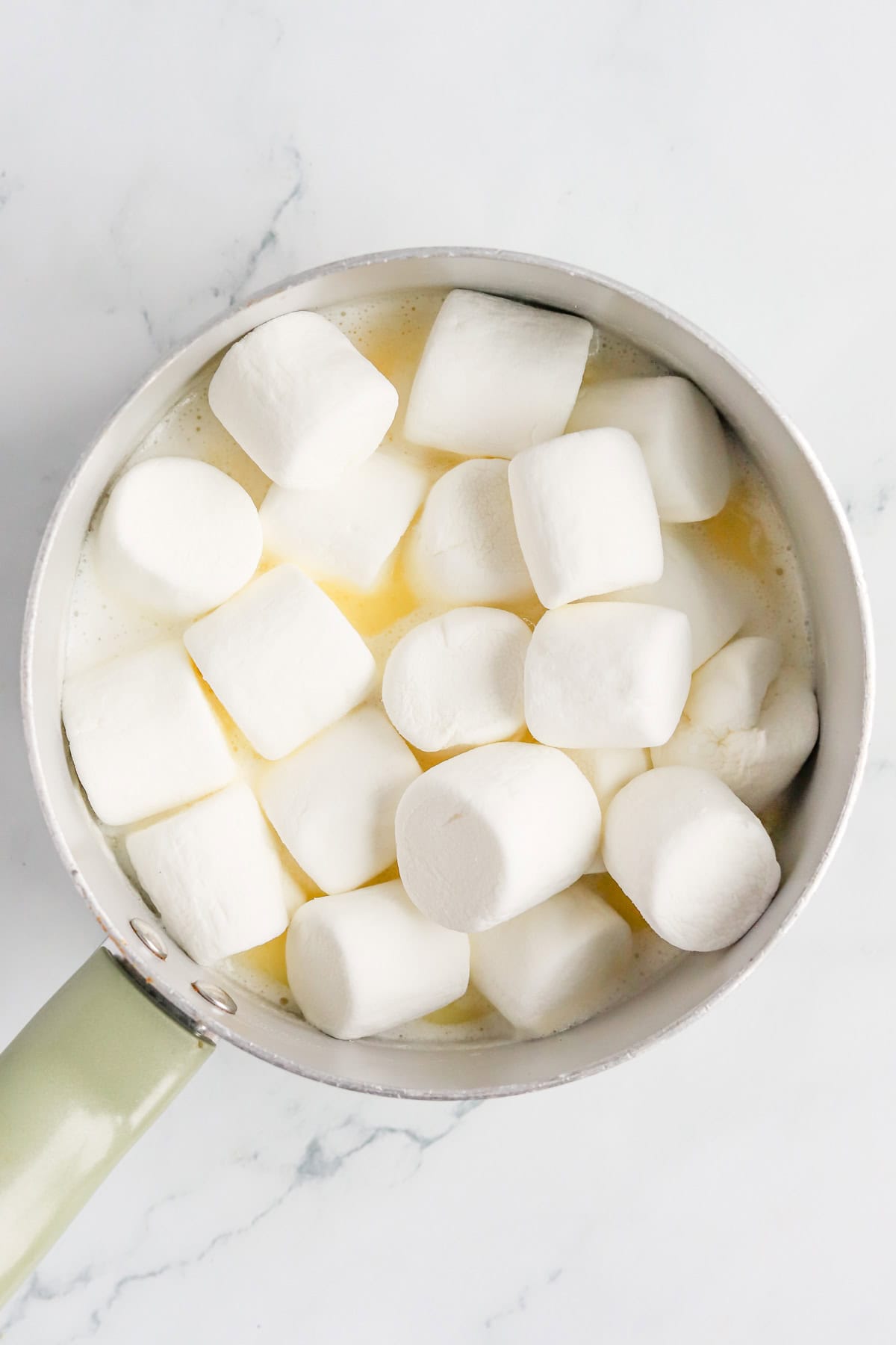 Marshmallows added to sauce pan of melted butter and milk.