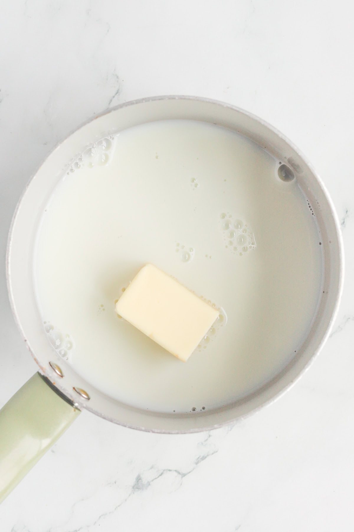 Butter and milk in a saucepan.