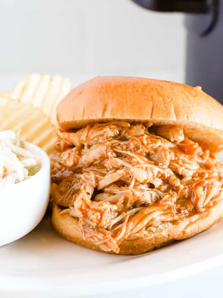 Featured image of bbq pulled chicken sandwich on a white plate