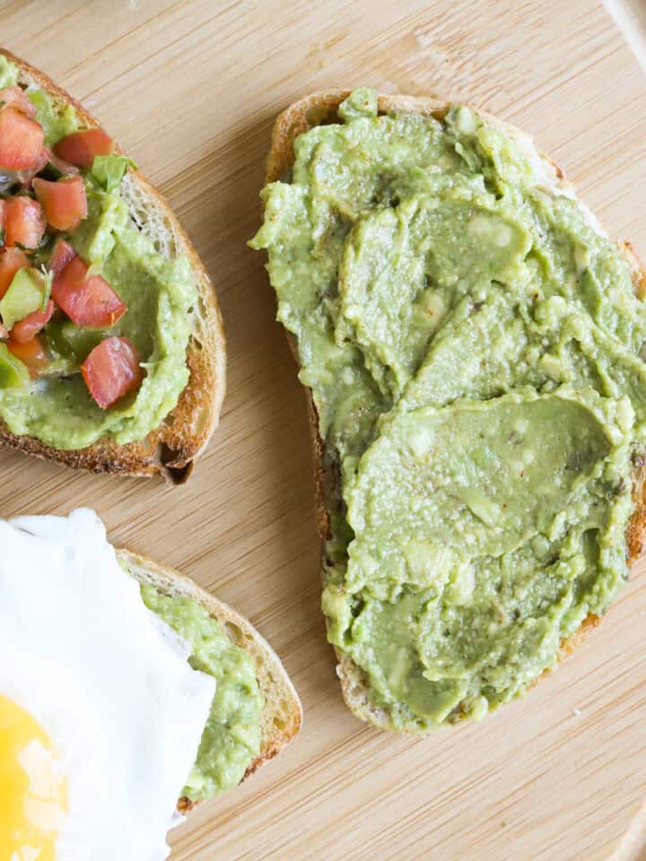 Featured image of guacamole on sourdough toast. One plain, one topped with a sunny side egg and one with pico de Gallo on top.