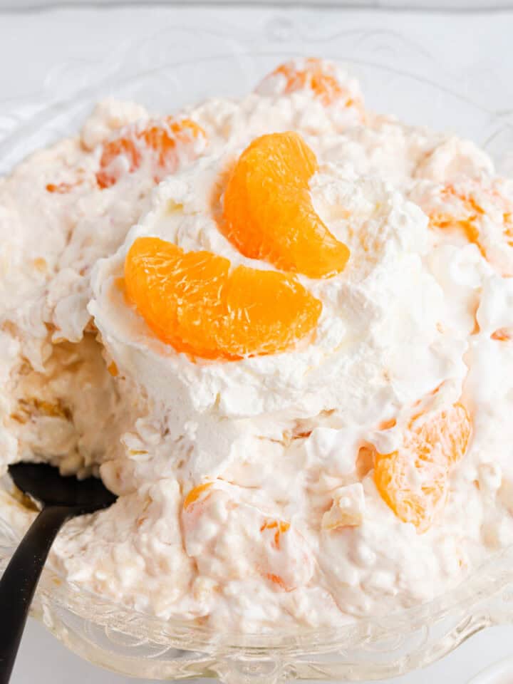 Featured image of orange cottage cheese salad in a decorative glass bowl.