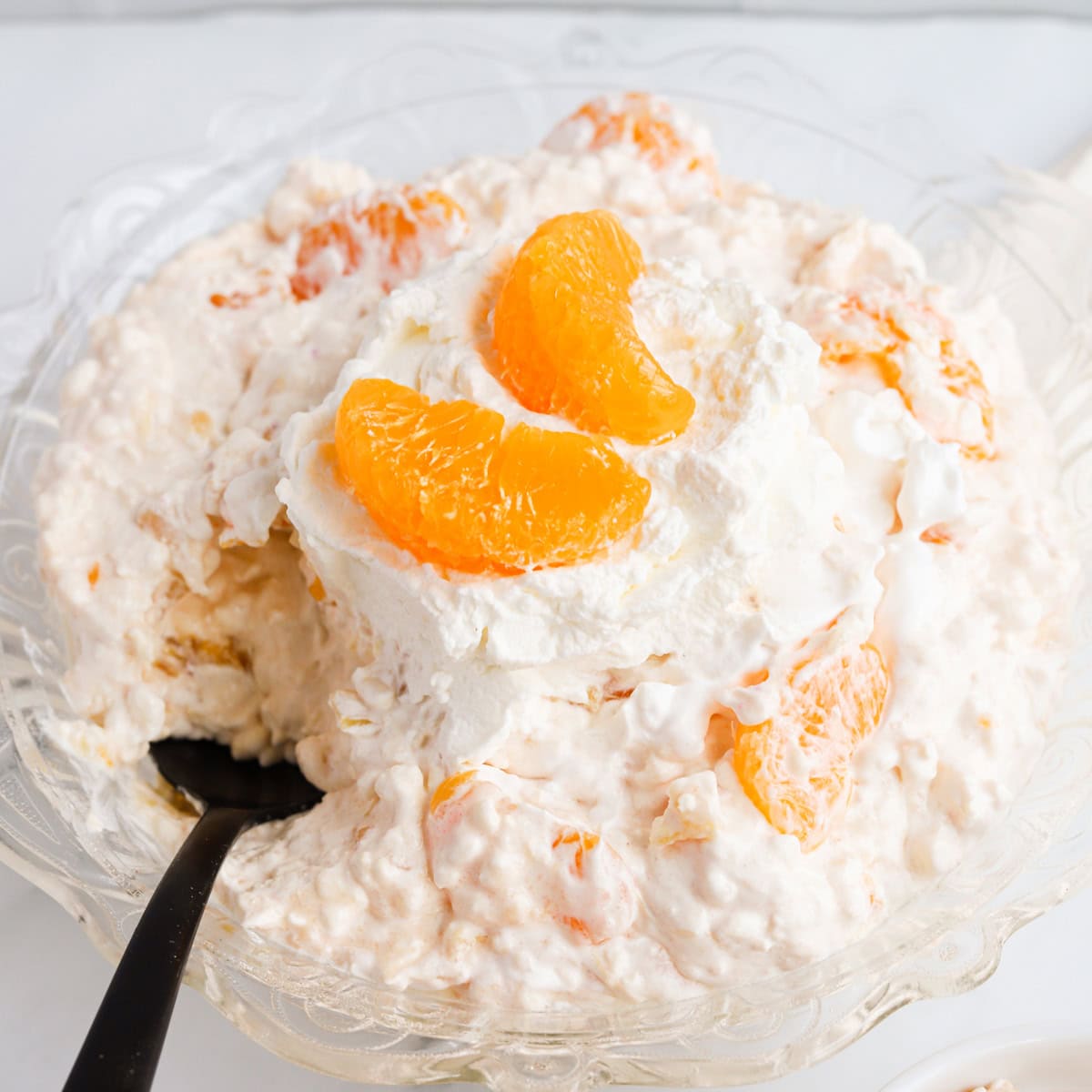 Featured image of orange cottage cheese salad in a decorative glass bowl.