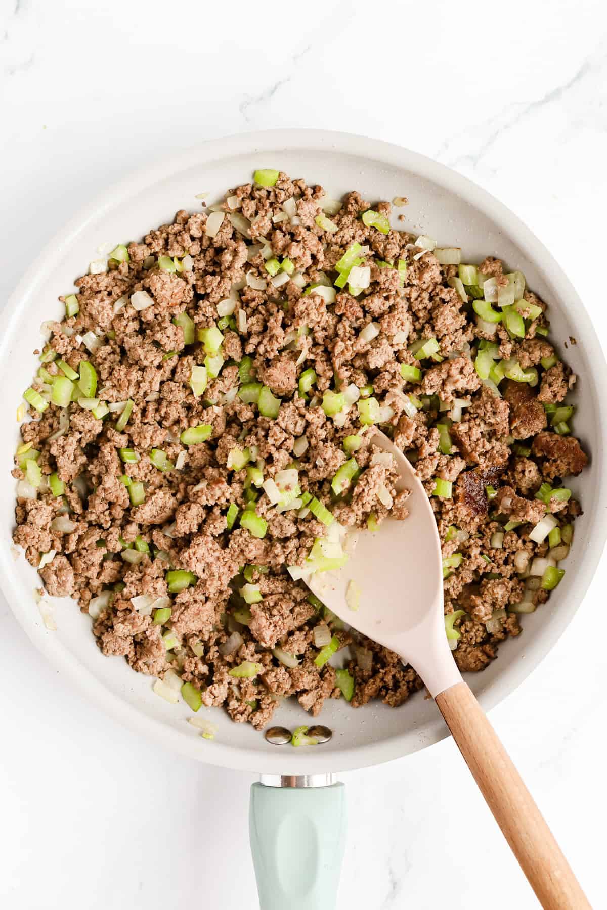 Skillet of cooked ground beef, onion and celery